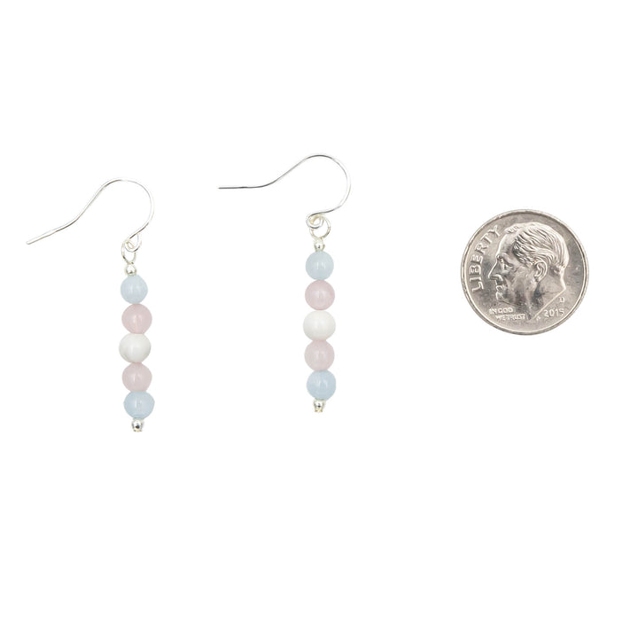 Earth Song Jewelry Trans Pride Stone Sterling Silver Earrings for women next to coin for sizing