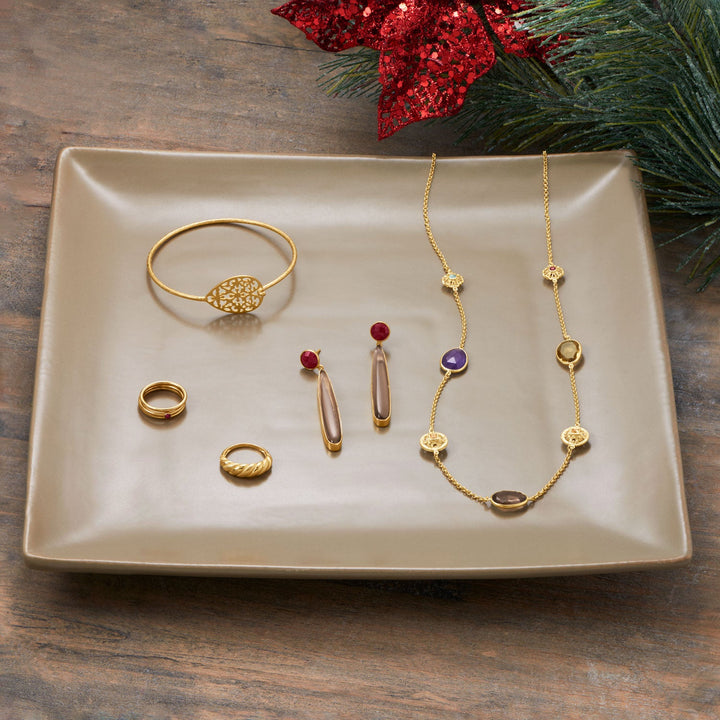 Earth Song Jewelry layout gold jewelry on dish
