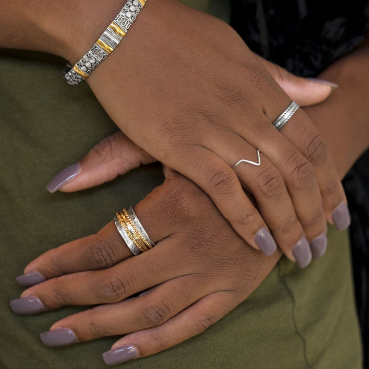 Earth Song Jewelry model showing sterling silver gold spinner ring