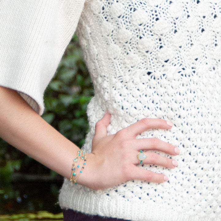 Earth Song Jewelry model wearing gold moonstone and turquoise jewelry