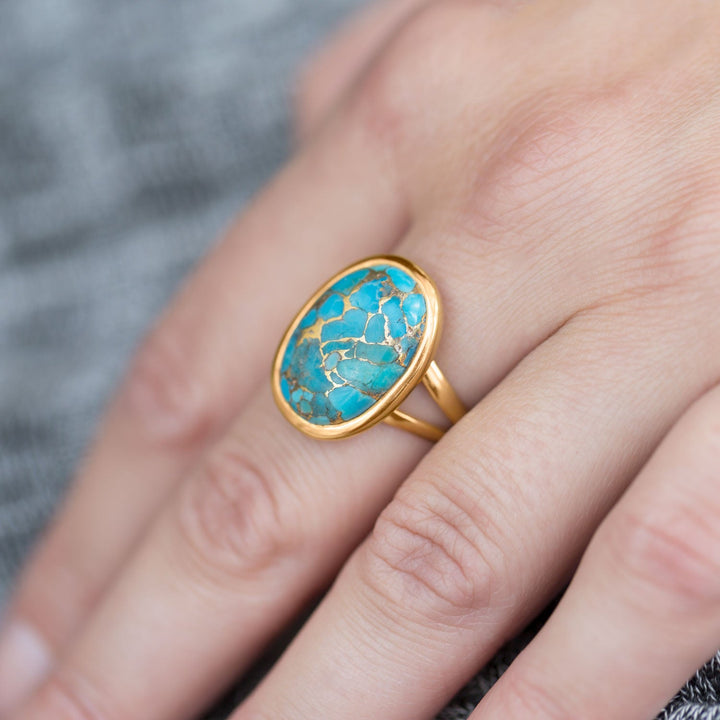 Earth Song Jewelry model wearing gold sterling silver turquoise ring