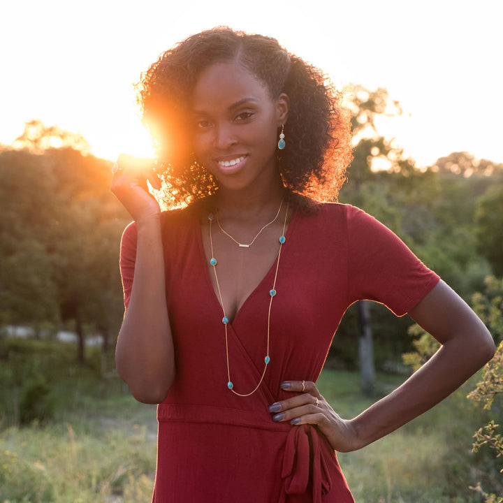 Earth Song Jewelry model wearing gold turquoise jewelry