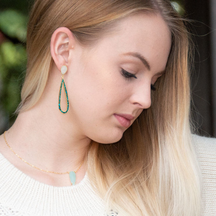 Earth Song Jewelry model wearing moonstone and turquoise gold earrings