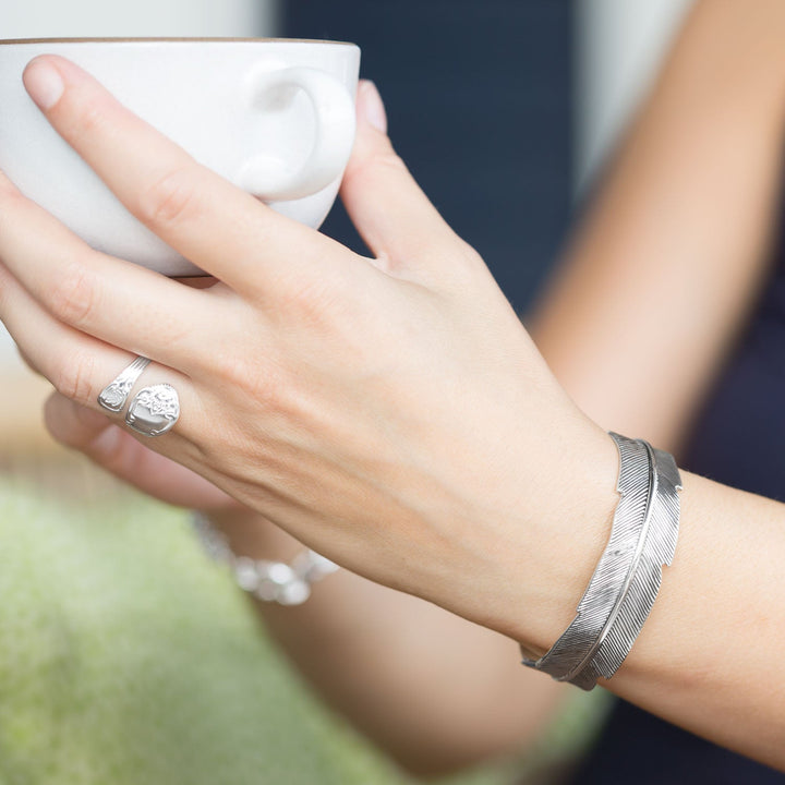 Earth Song Jewelry model wearing sterling silver feather cuff bracelet