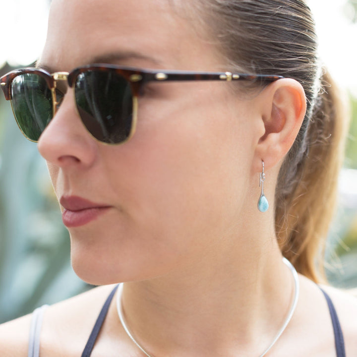 Earth Song Jewelry model wearing sterling silver larimar drop earrings