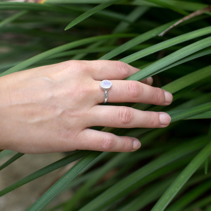 Earth Song Jewelry model wearing sterling silver rainbow moonstone ring