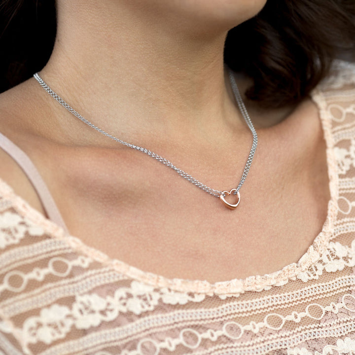 Earth Song Jewelry model wearing sterling silver rose gold heart necklace