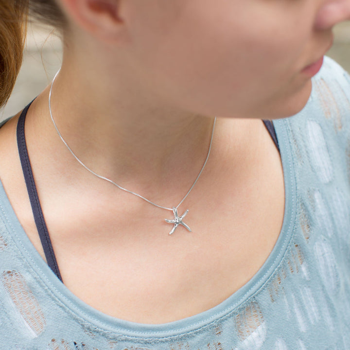 Earth Song Jewelry model wearing sterling silver starfish necklace