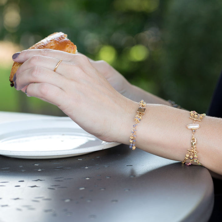 Earth Song Jewelry model with gold multistrand stone bracelets