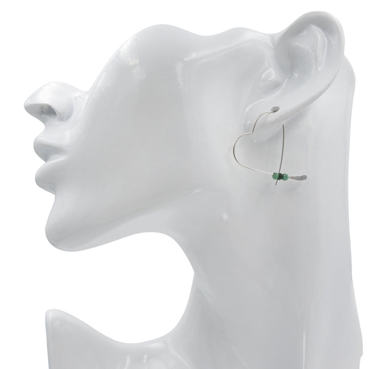 Earth Song Jewelry Handmade Sterling Silver Heart Earrings with Emerald stones on mannequin head