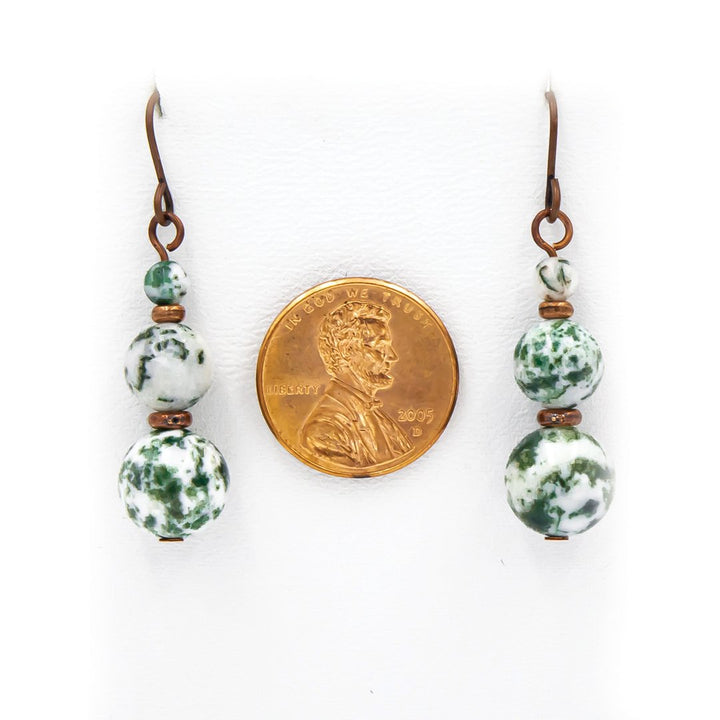 Earth Song Jewelry handmade Snowy Tree Tops - Tree Agate earrings. Next to a coin for sizing context.
