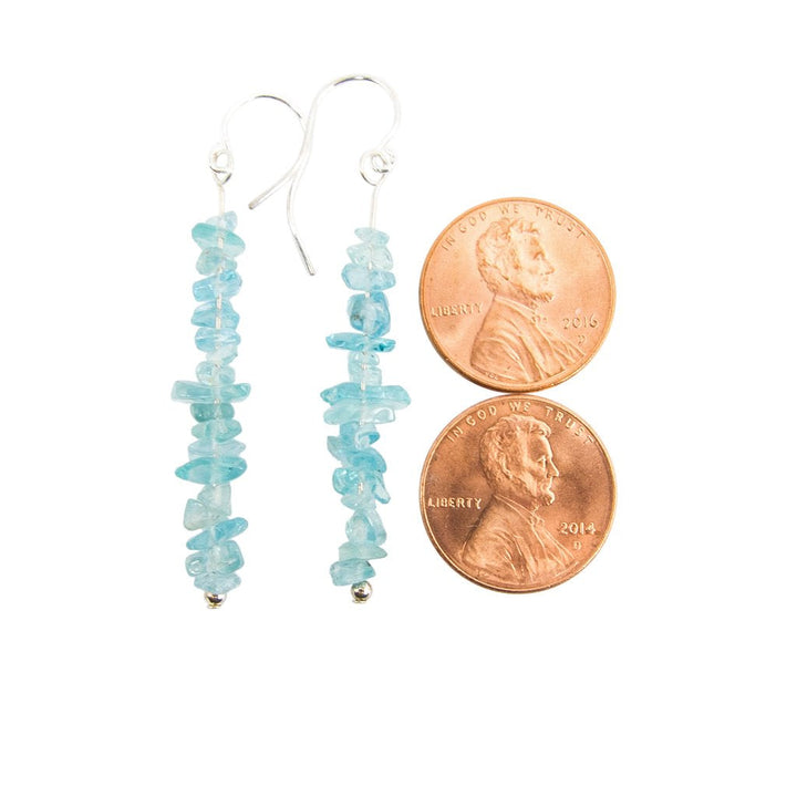 Earth Song Jewelry handmade Chips Of Ice Apatite earrings. Made with 925 sterling silver. Next to a coin for sizing context.